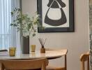 Modern dining room with round table and contemporary artwork