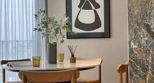 Modern dining room with round table and contemporary artwork