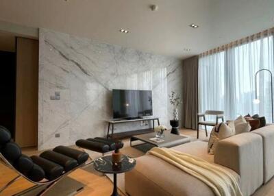 Modern living room with marble accent wall, large windows, and contemporary furniture