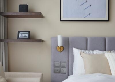 Modern bedroom with wall-mounted shelves and framed art