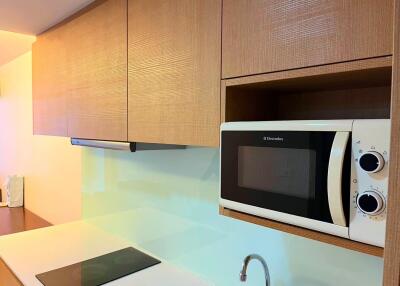 Modern kitchen area with microwave and stove