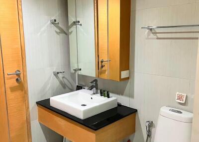 Modern bathroom with vanity, mirror, and toilet