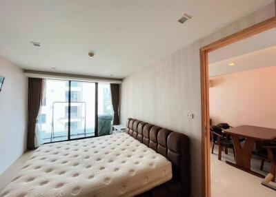 Spacious bedroom with large windows and connected balcony