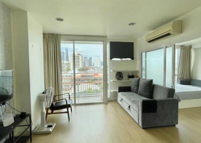 Spacious living area with large windows and city view