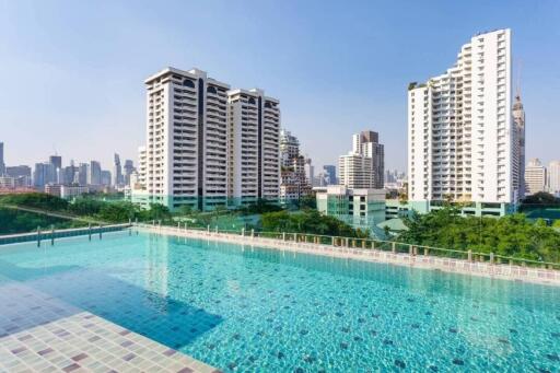 Outdoor pool with cityscape background