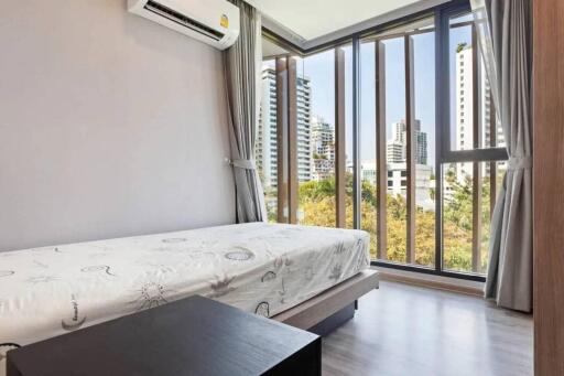 Modern bedroom with large windows and city view