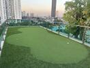 Rooftop view with artificial grass and cityscape