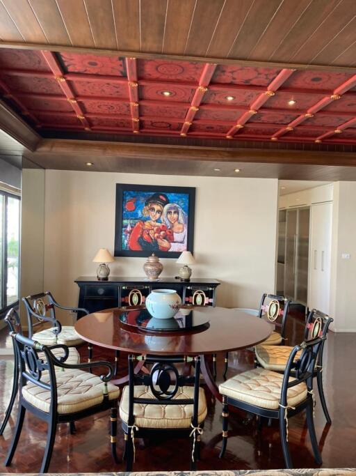 Elegant dining room with wooden ceiling and modern art