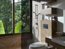 Modern bathroom with large window overlooking greenery, walk-in shower and wall-mounted toilet.