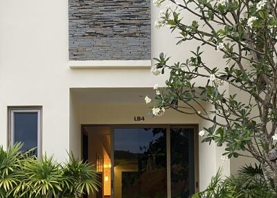 Front entrance of a modern home with greenery