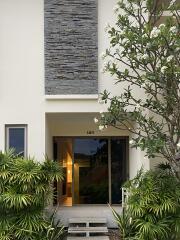 Front entrance of a modern home with greenery