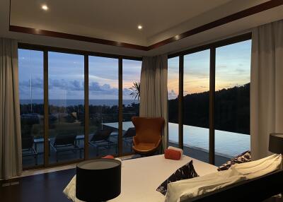 Bedroom with large windows overlooking a scenic view