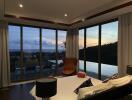 Bedroom with large windows overlooking a scenic view