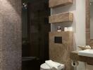 Modern bathroom with tiled shower area and wall-mounted toilet