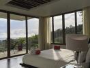 Modern bedroom with large windows and balcony view