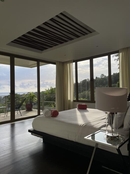 Modern bedroom with large windows and balcony view