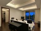 Modern bedroom with dark wood flooring, an elegant bed, a desk, and large windows.