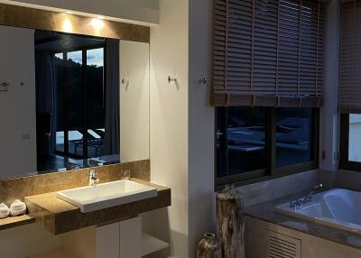 Bathroom with modern fixtures and large windows