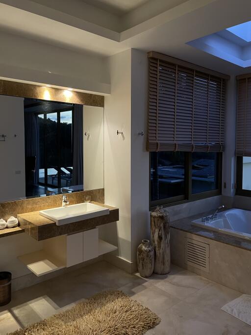 Bathroom with modern fixtures and large windows