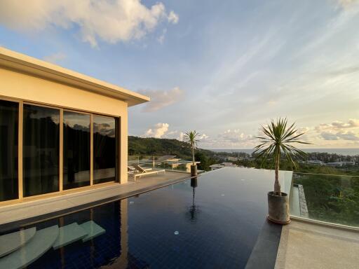 View of the outdoor area with infinity pool and scenic landscape