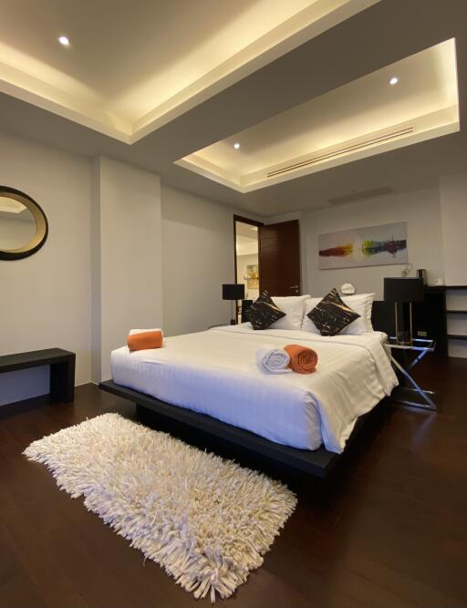 Modern bedroom with recessed lighting and stylish decor