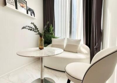 Cozy corner with a round table, chair, and sofa
