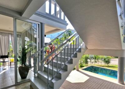 View of a staircase with pool and outdoor area
