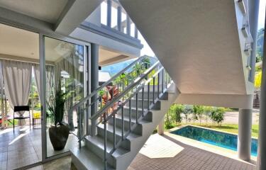 View of a staircase with pool and outdoor area