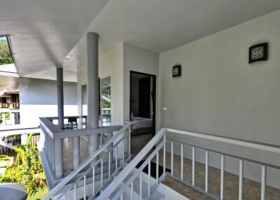 Modern apartment exterior with a visible staircase and a partial view of the interior