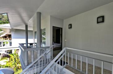 Modern apartment exterior with a visible staircase and a partial view of the interior