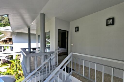 Modern apartment exterior with a visible staircase and a partial view of the interior