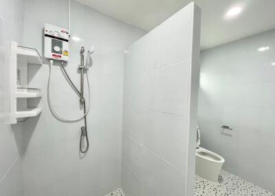 Bright white bathroom with shower and toilet