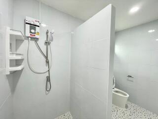 Bright white bathroom with shower and toilet