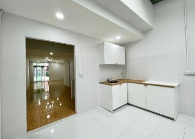 Modern white kitchen with wooden countertop