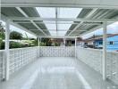 Spacious covered balcony with tiled floor and decorative railing