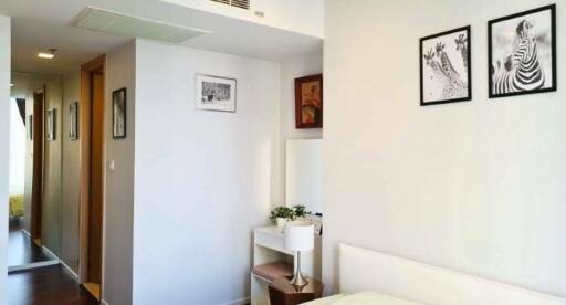 Modern bedroom with framed artwork and desk