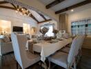 Elegant dining room with table set for dinner and cozy living area