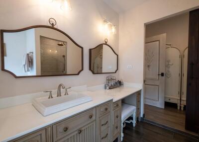 Well-lit bathroom with twin mirrors and a large vanity