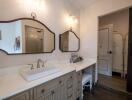 Well-lit bathroom with twin mirrors and a large vanity