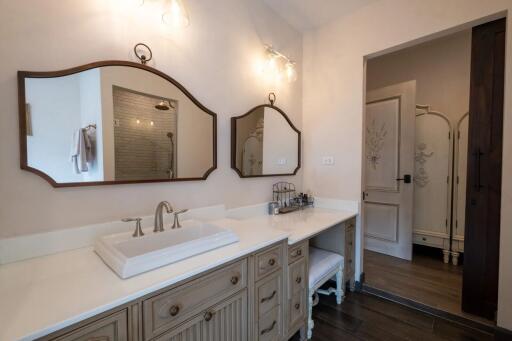 Well-lit bathroom with twin mirrors and a large vanity