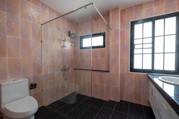 Modern bathroom with glass shower and window