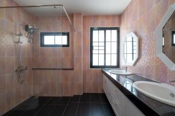 Modern bathroom with double sink and walk-in shower