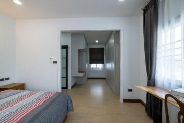 Modern bedroom with attached study area and large window