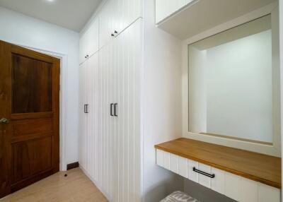 Bedroom with built-in white wardrobes and wooden door