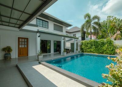 Outdoor area with swimming pool and landscaping