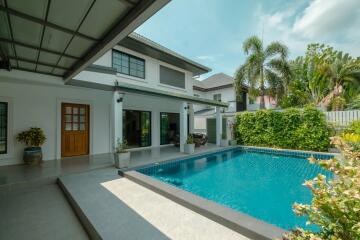 Outdoor area with swimming pool and landscaping