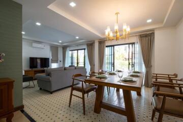 Spacious living room with dining area and large windows