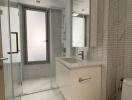 Modern bathroom with glass shower and white vanity