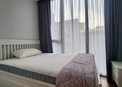 Bedroom with a large bed and floor-to-ceiling windows