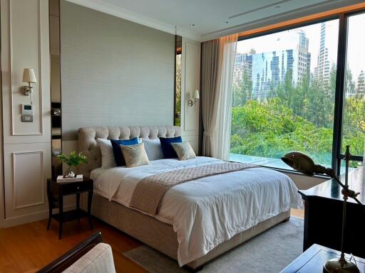 Modern bedroom with large windows and city view